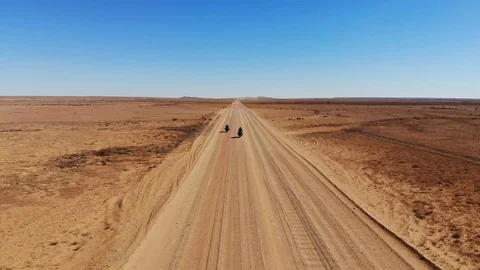 Two Motorcyclists riding down an Outback Road in Australia Video stock 113782210