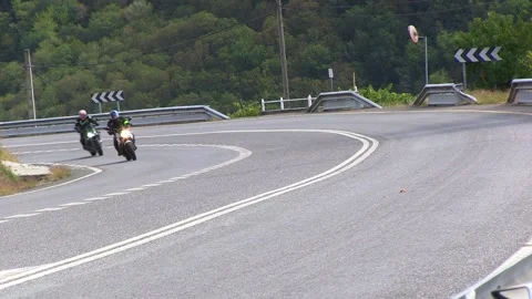 TWO MOTORISTS TAKING THE CURVE Stock Footage 96331838
