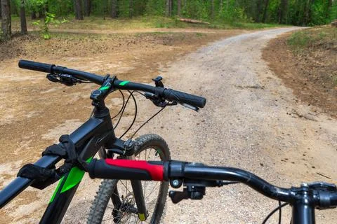 Two mountain bicycles in forest, handlebars, Shift lever and brake lever close Stock Photos