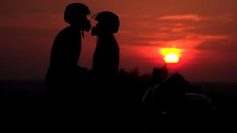 Two mountain biker - comantic couple silhouette in sunrise Stock Photos