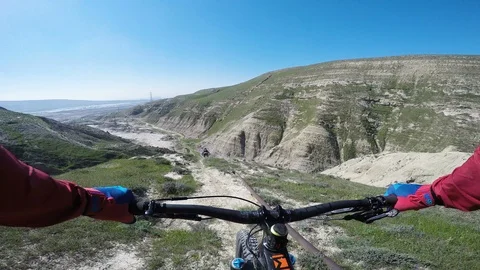 Two Mountain Bikers Riding Fast Down Steep Desert Ridge On A Sunny Day Stock-Footage 101497573