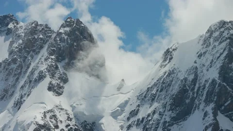 Two mountain peaks and pass view among the white clouds and blue sky. Scenic Stock Footage 169706629