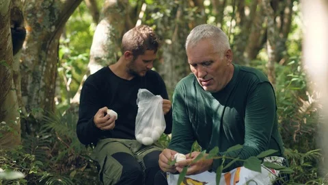 Two mountainers eating boiled eggs in the jungle. Stock Footage 116404743