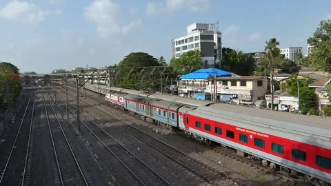Two moving trains meet, Superfast Rajdhani Express with Mumbai Local Train India Stock Footage 130595067