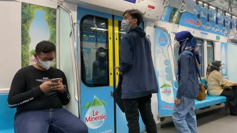 Two MRT Passengers Disembark at One of Its Subway Stations During Pandemic Stock Footage 156649984