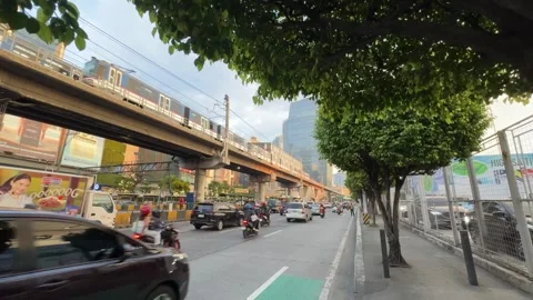Two MRT Trains Passing EDSA Ortigas Golden Hour Traffic Skyline Wide 4K 60fps Stock Footage 338186606
