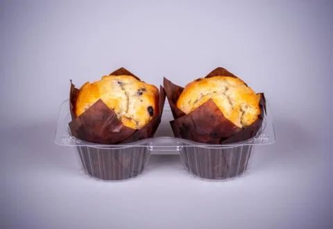 Two muffins in plastic packaging Stock Photos