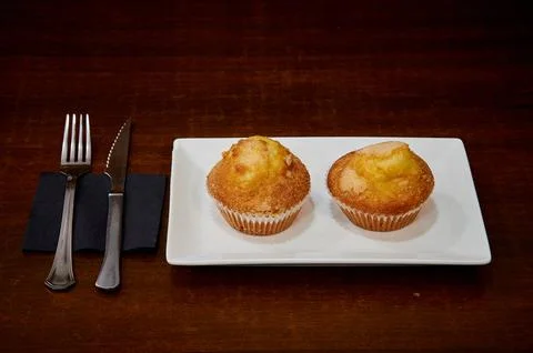 Two muffins on a white plate Stock Photos