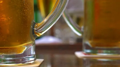 Two mugs of beer on the table. Stock Footage 110734032