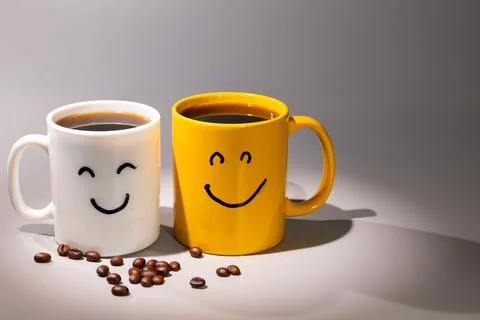 Two Mugs of Coffee With Happy Faces, a Cheerful Morning Beverage Concept Stock Photos