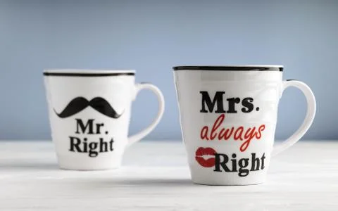 Two mugs with printed text Mr. right and Mrs. always right. Funny phrase abou Stock Photos