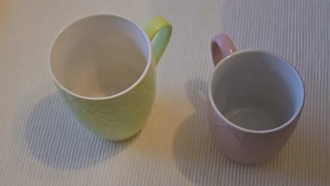 Two mugs on table with shadow, minimal kitchen lifestyle, white background, Copy Stock Footage 334993113