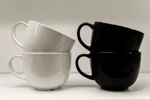 Two mugs on a white background are standing. Stock Photos