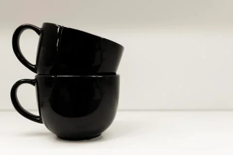 Two mugs on a white background are standing. Stock Photos