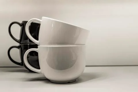 Two mugs on a white background are standing. Stock Photos
