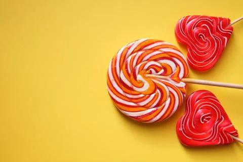 Two multi-colored lollipops in the shape of a heart. Round multi-colored Stock Photos