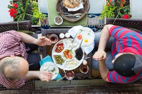 Two multi denominational men praying over food Stock Photos