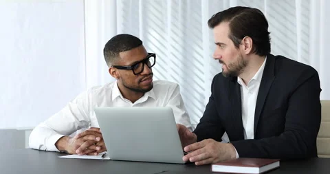 Two multi ethnic businessmen having formal meeting in office Stock Footage 168598320
