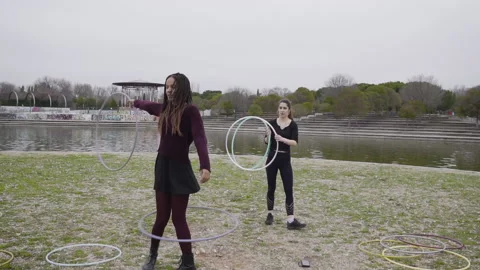 Two multi-ethnic friends of enjoying Hula Hoop dance 库存影片 130433800