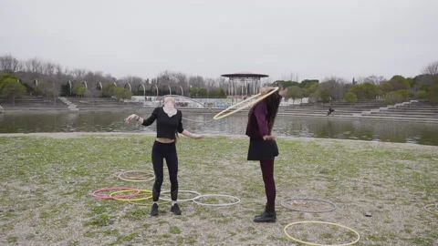 Two multi-ethnic friends of enjoying Hula Hoop dance 库存影片 130435318