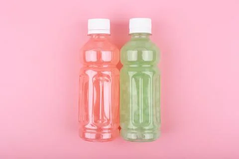 Two multicolored detox drinks or healthy smoothies in transparent plastic Stock Photos