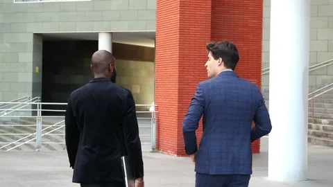 Two Multicultural Businessmen Walking to Work in Financial District, One Af.. Stock Footage 279800592