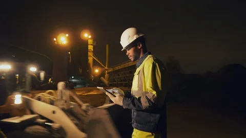 Two multicultural engineers working night shift at construction site. Stock-Footage 124068090
