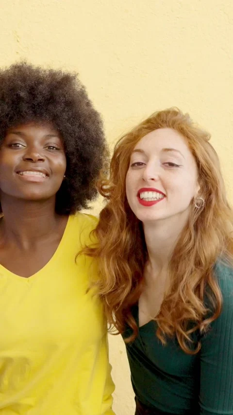 Two multicultural women smiling at camera outdoors Stock Footage 239900073