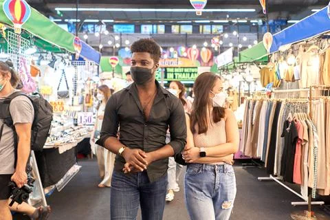 Two multiethnic friends visiting shops in a shopping mall Stock Photos