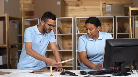 Two Multiethnic Post Office Clerks Registering Mail Stock Footage 114212653