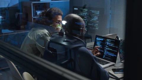 Two Multiethnic Software Developers Discussing Bugs Looking at Laptop Screen Stock Footage 329616031