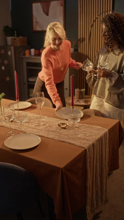 Two Multiethnic Women Setting Dining Table for Festive Friendsgiving Stock Footage 345234716