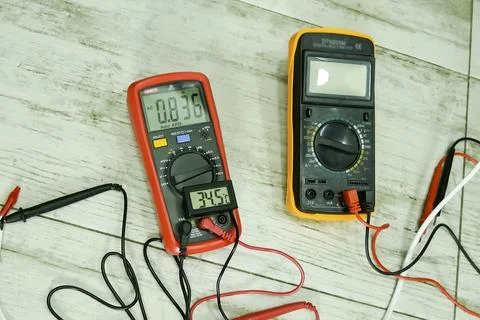 Two multimeters and thermometer on the table. Measuring instruments Stock Photos