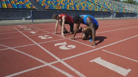 Two multiracial athletes getting to start and running after command, marathon Stock Footage 84727774