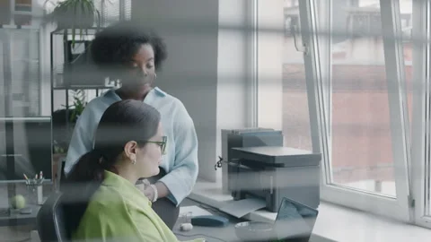 Two Multiracial Female Software Developers Discussing Program Code on Laptop Stock Footage 276202456