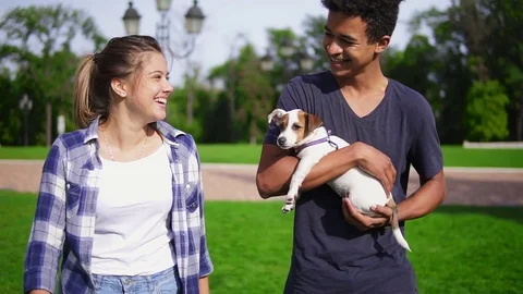 Two multiracial friends walking in park enjoying the summerday. Young attractive Stock Footage 80979979