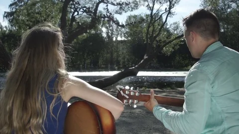 Two musicians are sitting on the bench Stock Footage 79859478
