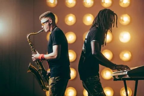 Two musicians performing on the stage Stock Photos