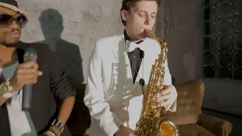 Two musicians show the performance. An African man is singing, a white man is Stock Footage 83136392