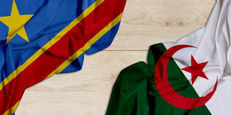 Two National Flags DR Congo And Algeria Draped On Wooden Surface, Symbolizing Un Stock Photos