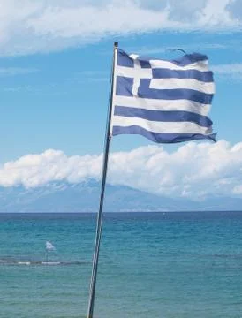Two national flags of Greece over the sea, with the island of Kefalonia Stock Photos