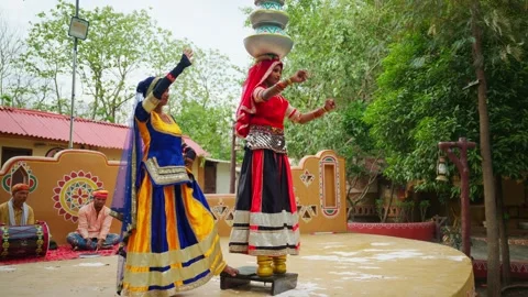 Two native dancer sway balancing vessels in courtyard Stock Footage 308057289