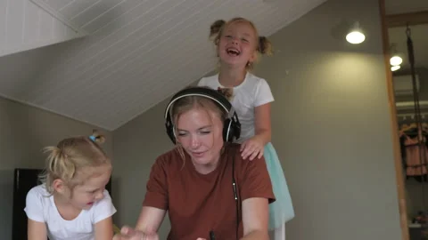 Two naughty daughters prevent her mother from working with her tablet at home Stock-Footage 144703593