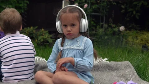 Two naughty Siblings dont share. boy ans girl listening to music on headphones Stock Footage 198528018