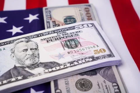 Two neat vertical stacks of United States dollar banknotes arranged over a .. Stock Photos