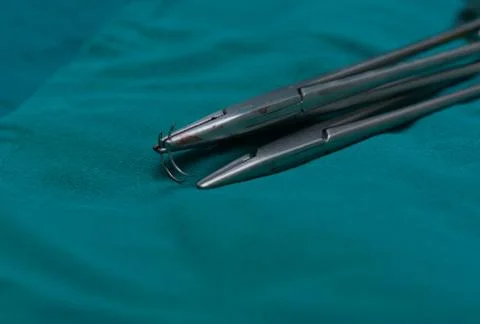 Two needle holders and empty needles on the table Stock Photos