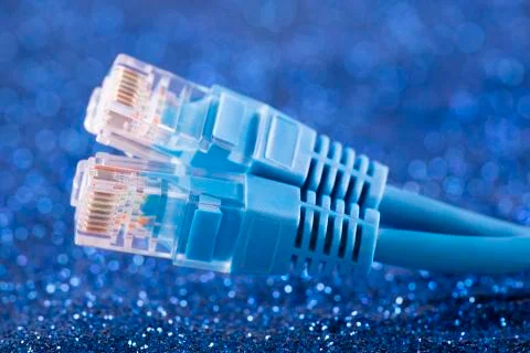 Two network cables over blue sparkles background Foto stock