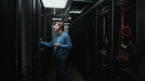 Two Network Engineers Inspecting Server Racks in Data Center Stock Footage 330544779