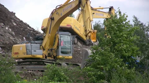 Two New Holland E265B crawler excavators working on a hill of rubble Stock Footage 41656758