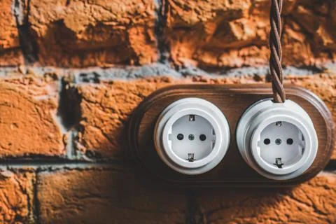 Two new plastic sockets with wire on the old wall Stock Photos